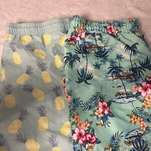 2 pairs of Tropical Print adult swimming trunks.